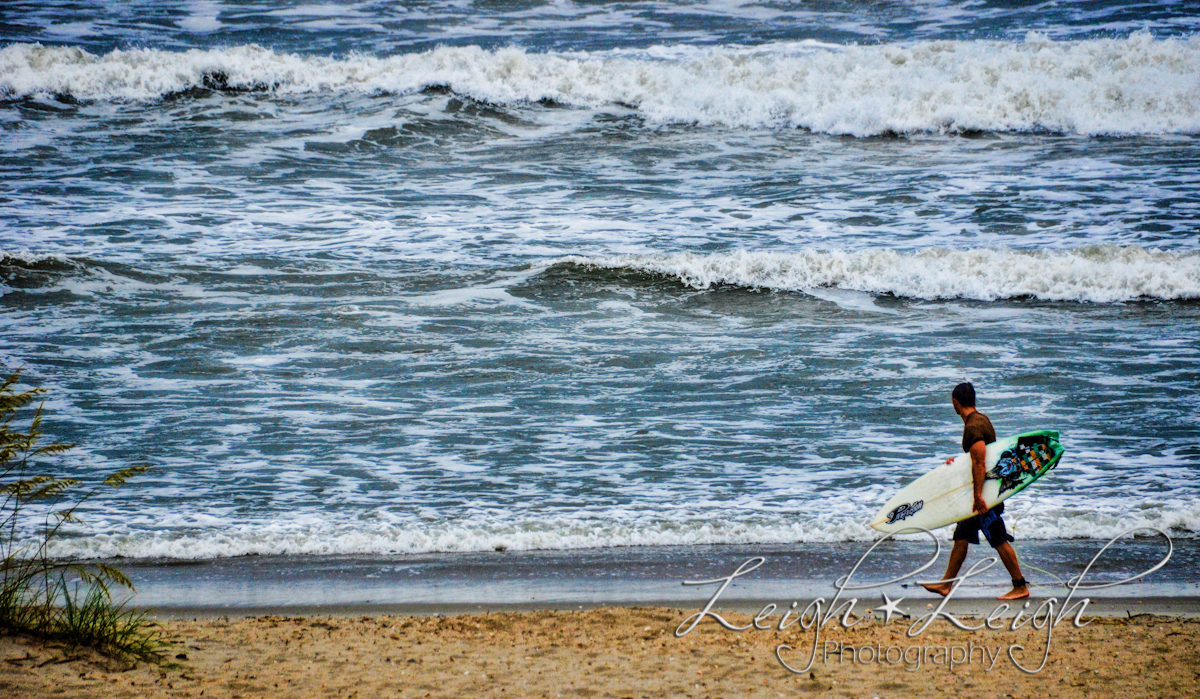 surfer walking on beach