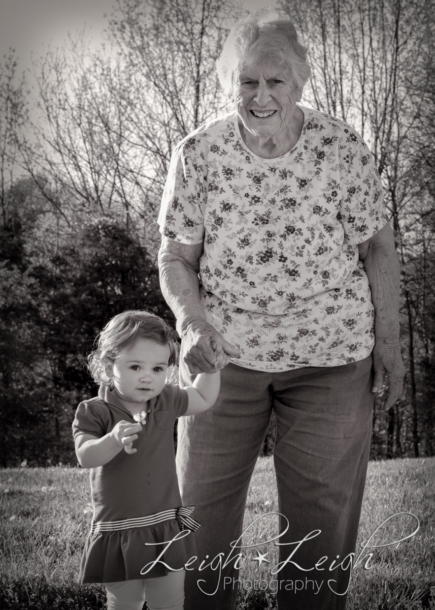 toddler holding hand of great-grandmother