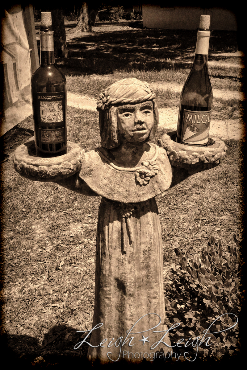 statue holding wine bottles