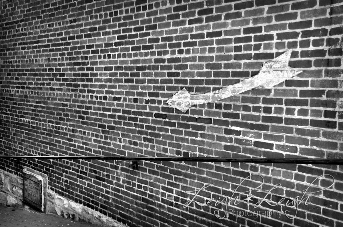 arrow painted on brick wall