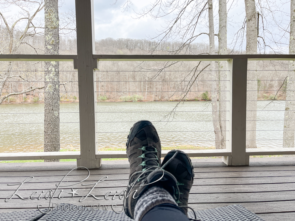 view of feet, deck, and lake