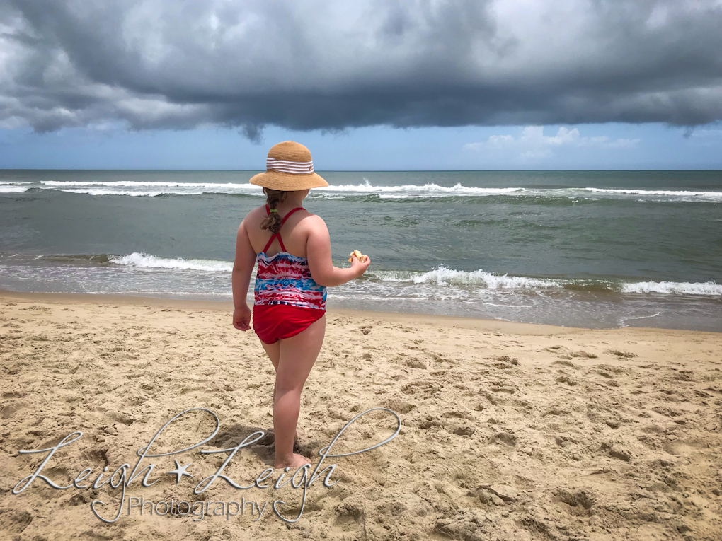 little girl looking at ocean