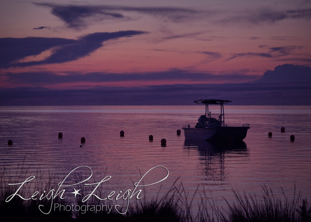 boat floating in the sound at sunset