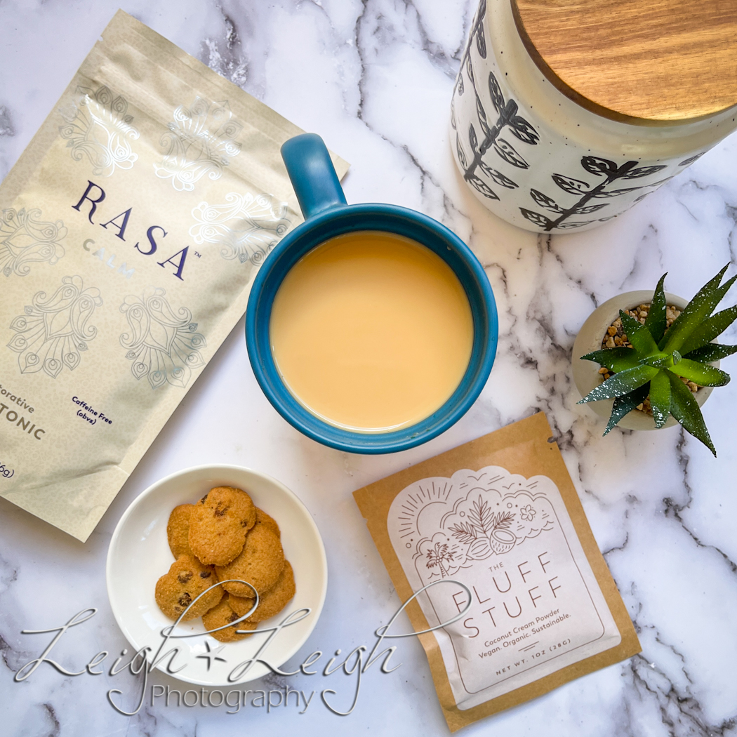 coffee cup, bag of Rasa, cookies, creamer, and jar