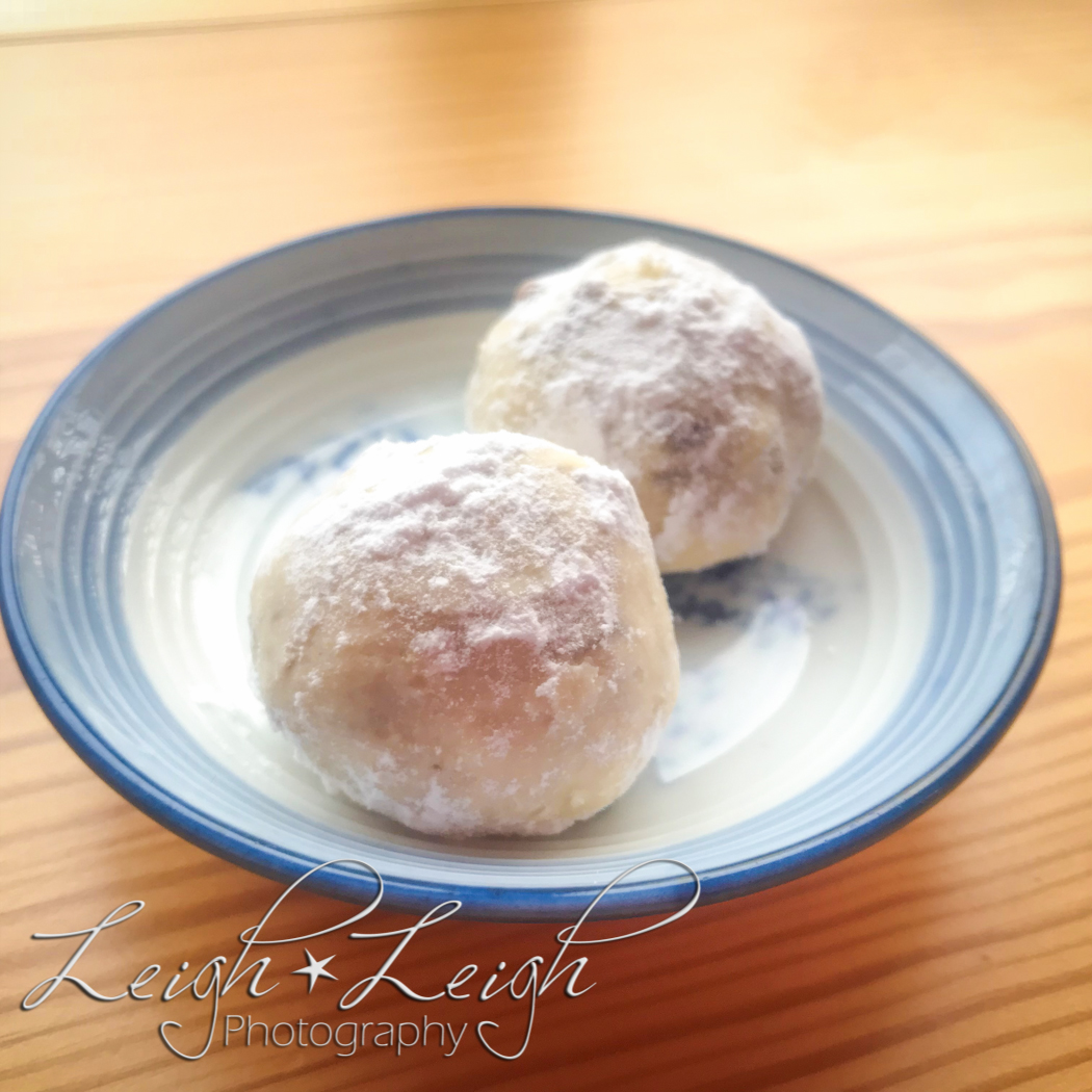 two snowball cookies on a plate