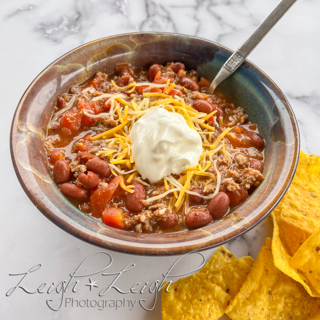 bowl of chili with side of chips