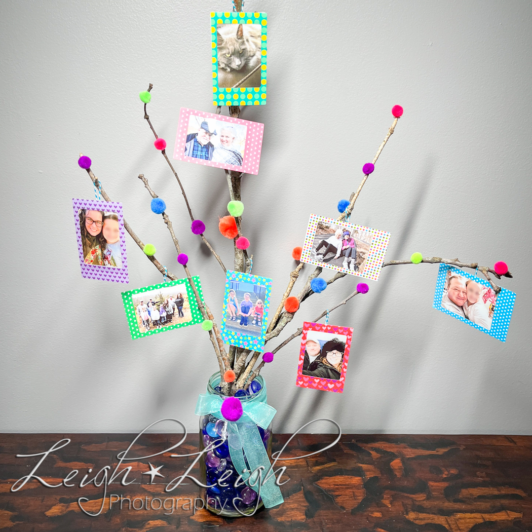 Photo tree made of sticks and small prints as ornaments