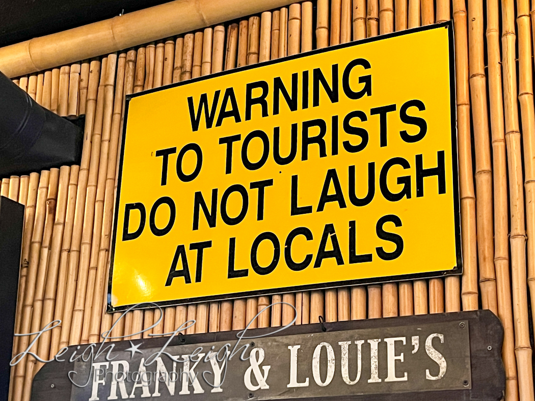 funny sign: warning to tourists do not laugh at locals