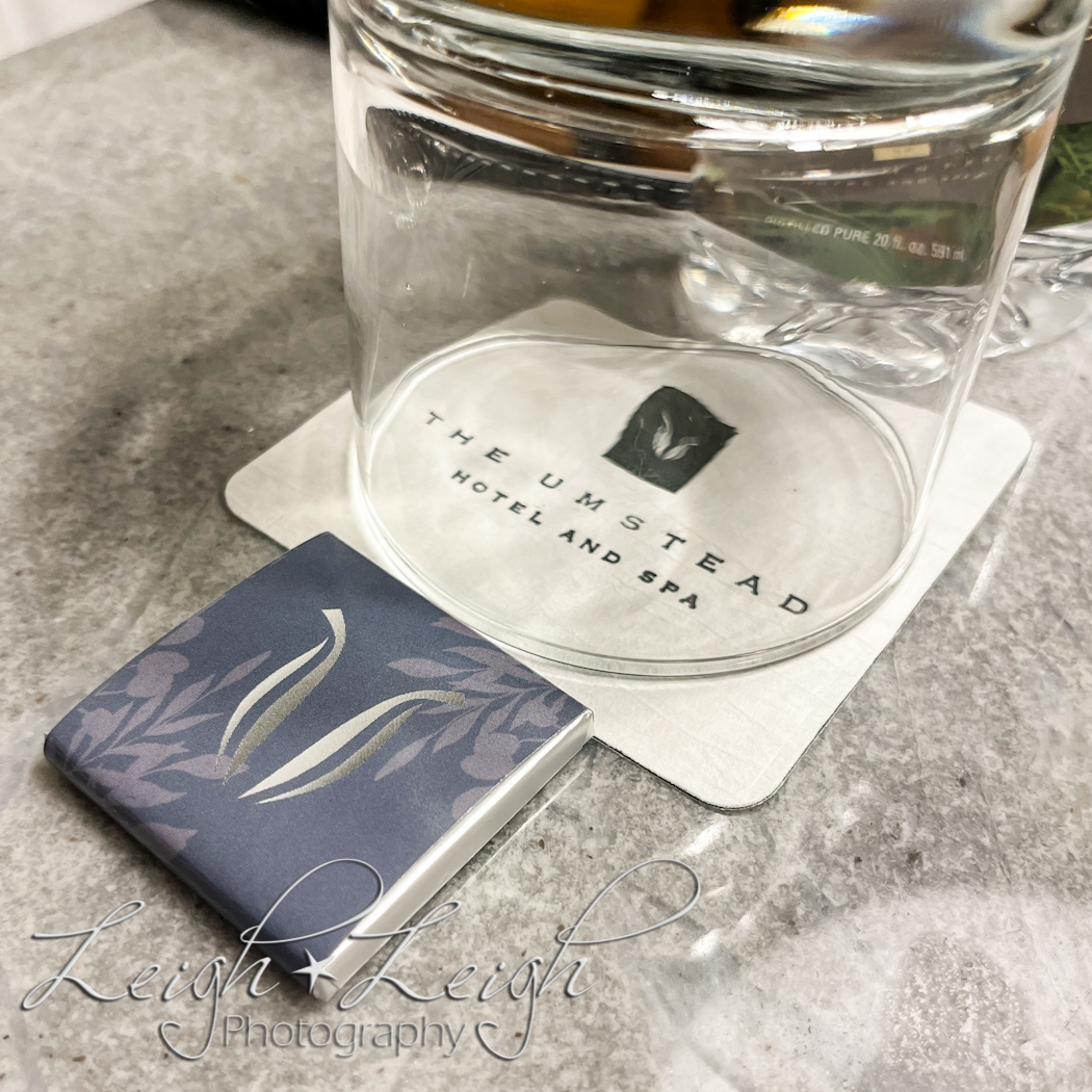 glass on nightstand with chocolate for turndown service