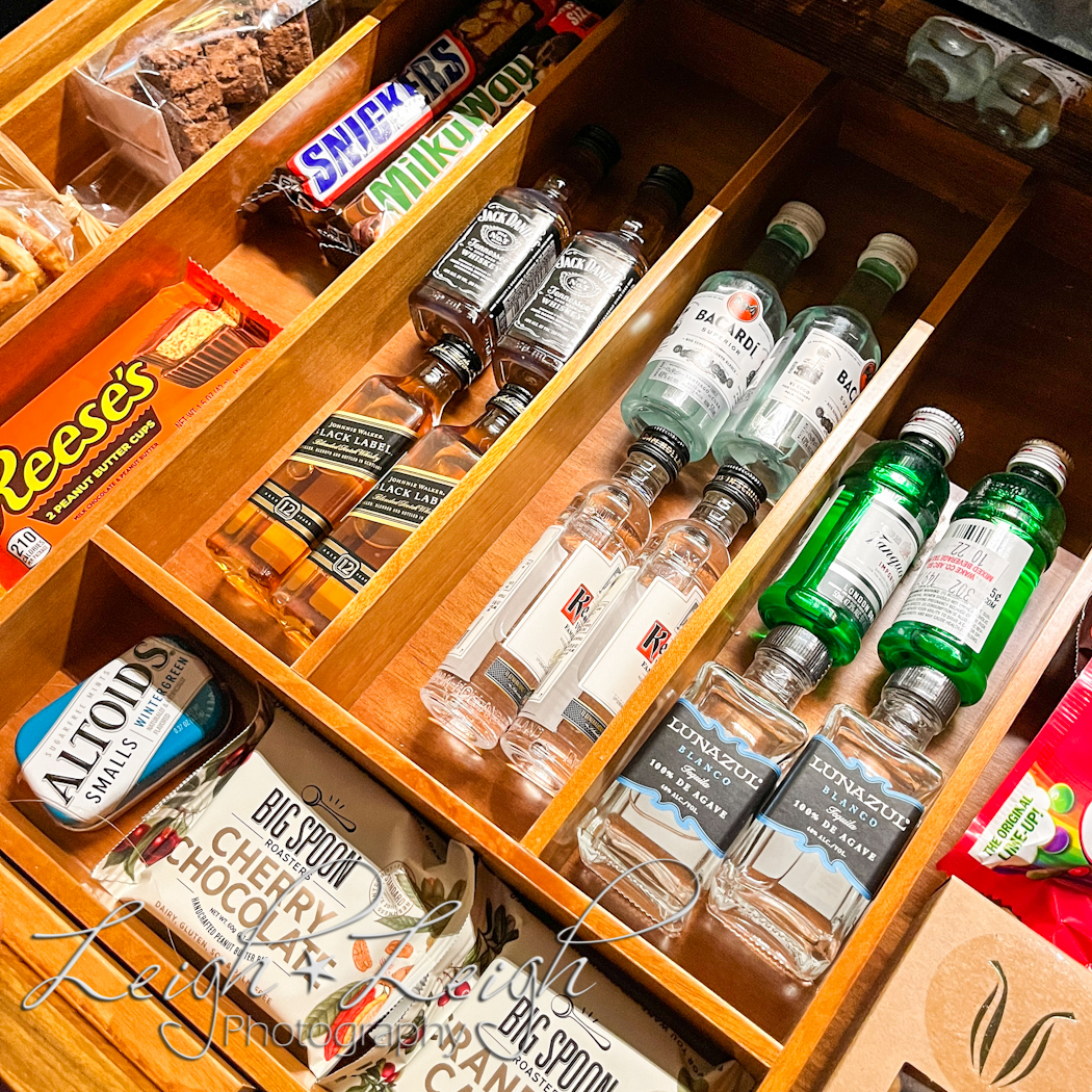 mini bar drawer full of liquor and snacks