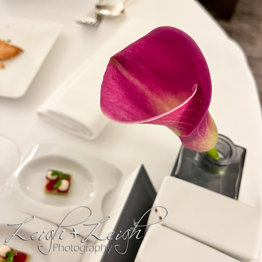 room service table with purple calla lily flower in vase