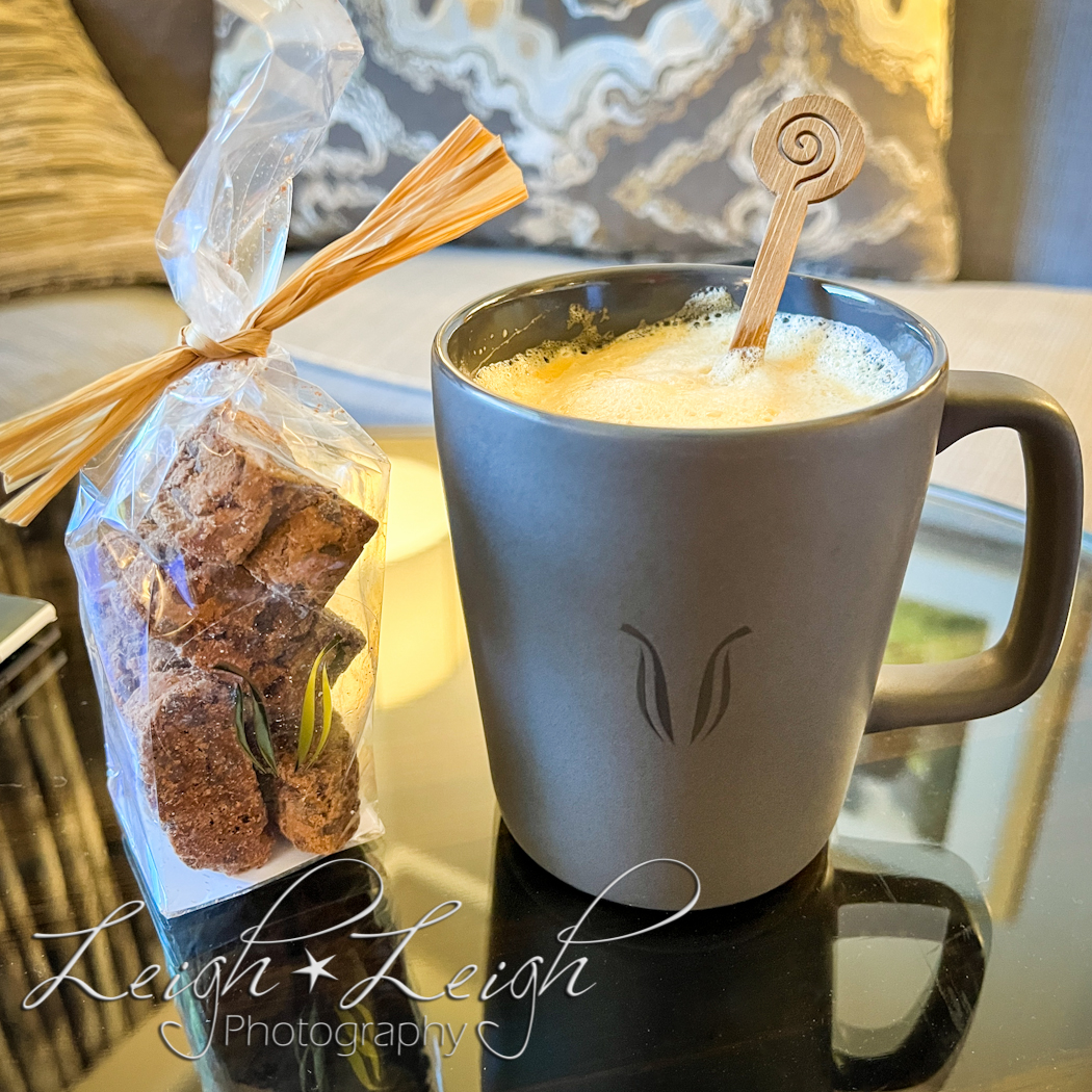 coffee mug and bag of biscotti sitting on table