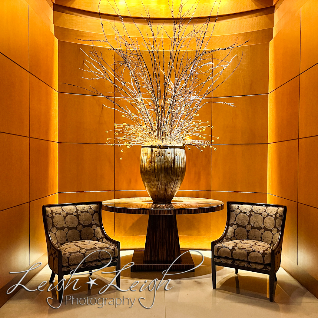 sitting area in hallway with fancy flower arrangement in the middle table