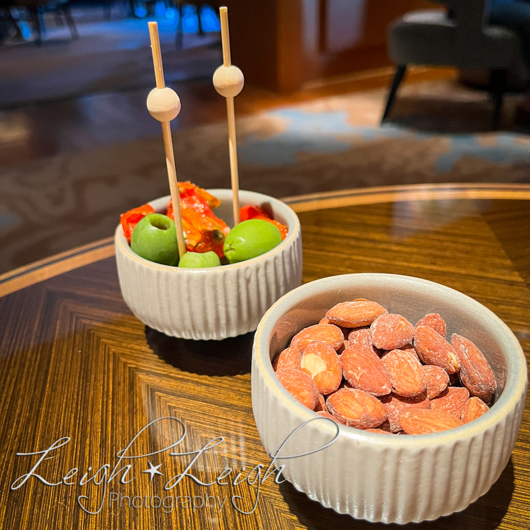 snack in lounge of almonds, olives, and tomatoes with fun fancy toothpicks