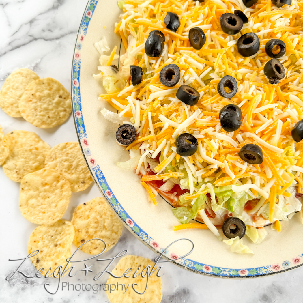 taco dip platter with chips around it