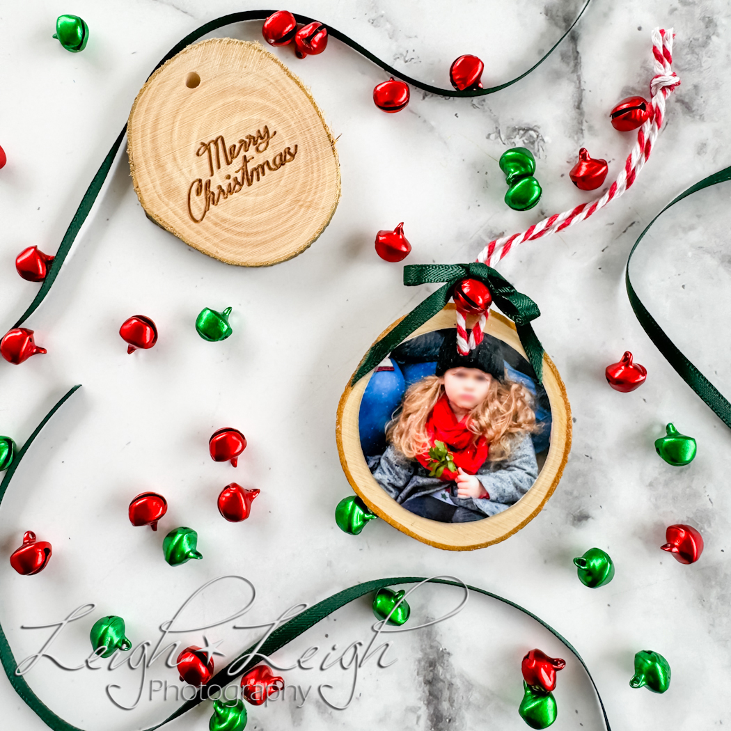 photo ornament made of wood circle surrounded by ribbon and bells