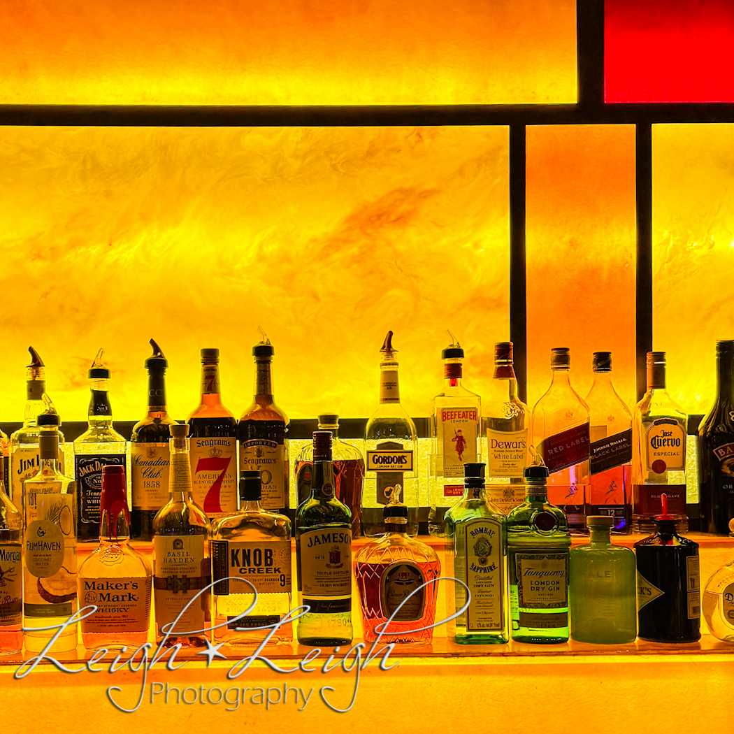 liquor bottles lined up on bar