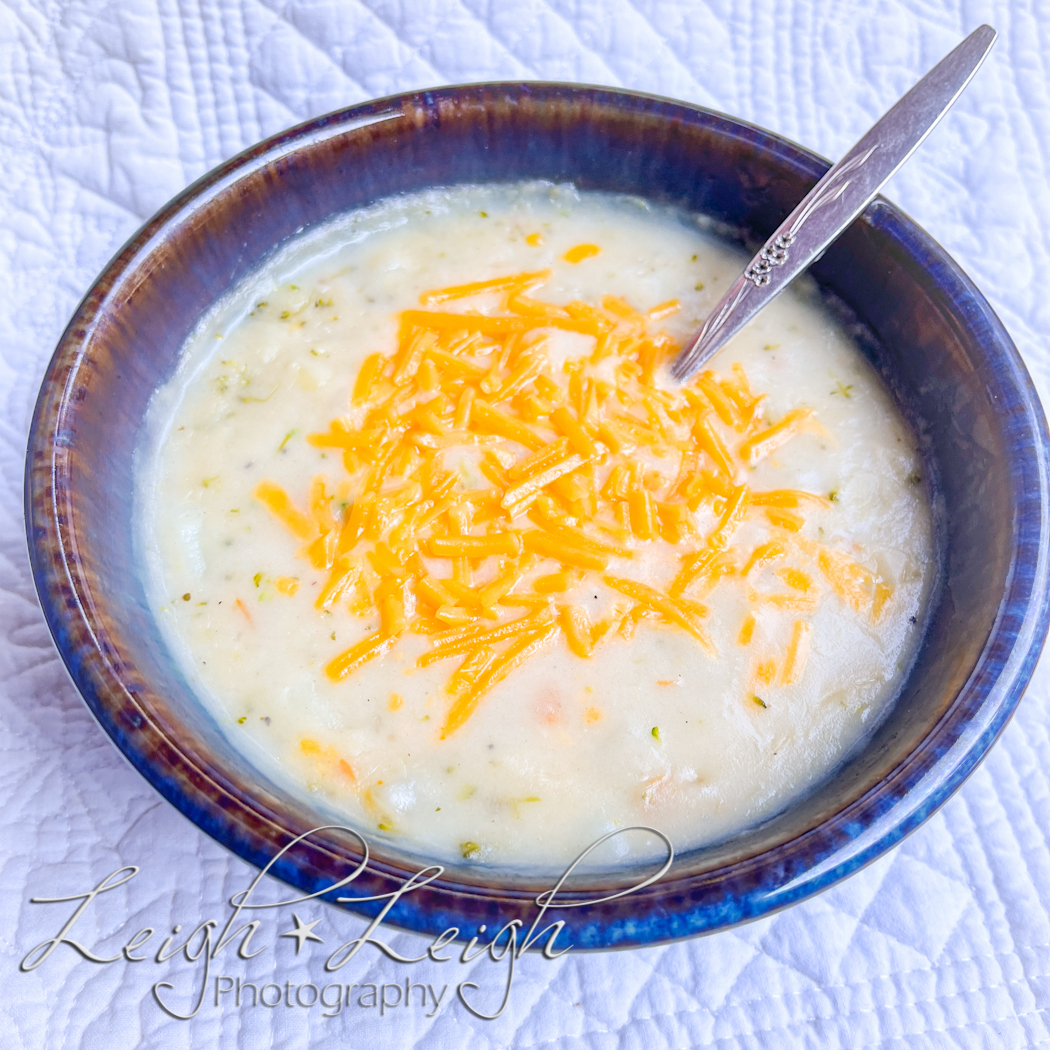 bowl of potato soup with cheese sprinkled on top