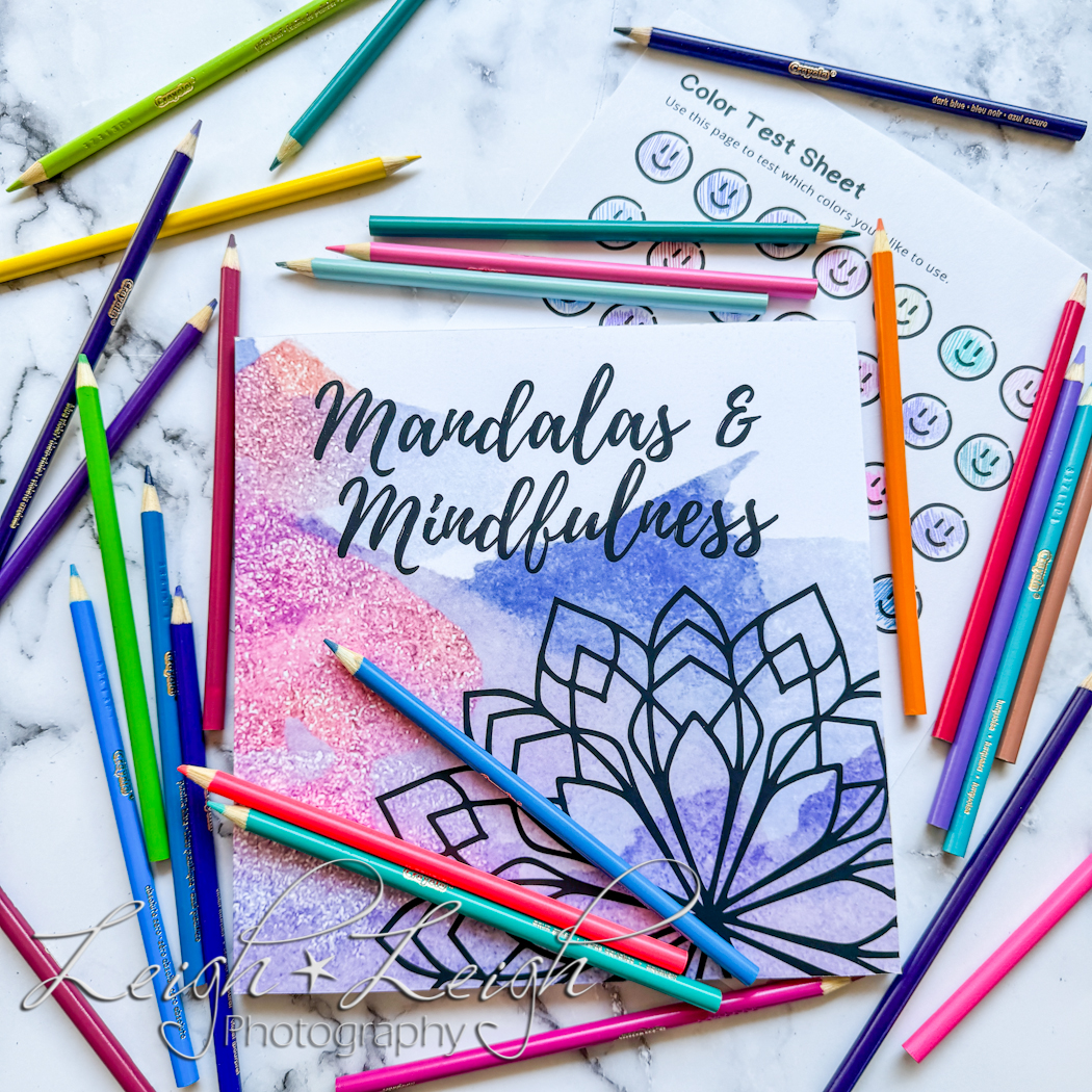 Mandalas and Mindfulness coloring book surrounded by colored pencils