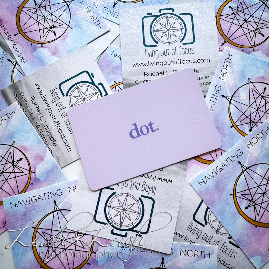 Dot Card sitting on top of a pile of paper business cards