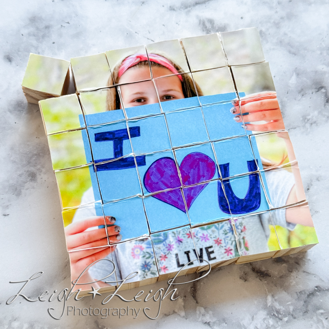 photo puzzle made out of wooden cubes - picture of girl holding sign that says:  I love you