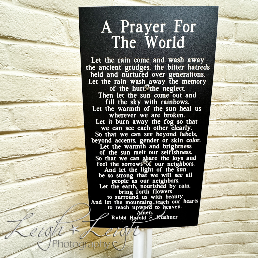 sign with A Prayer for the World on it