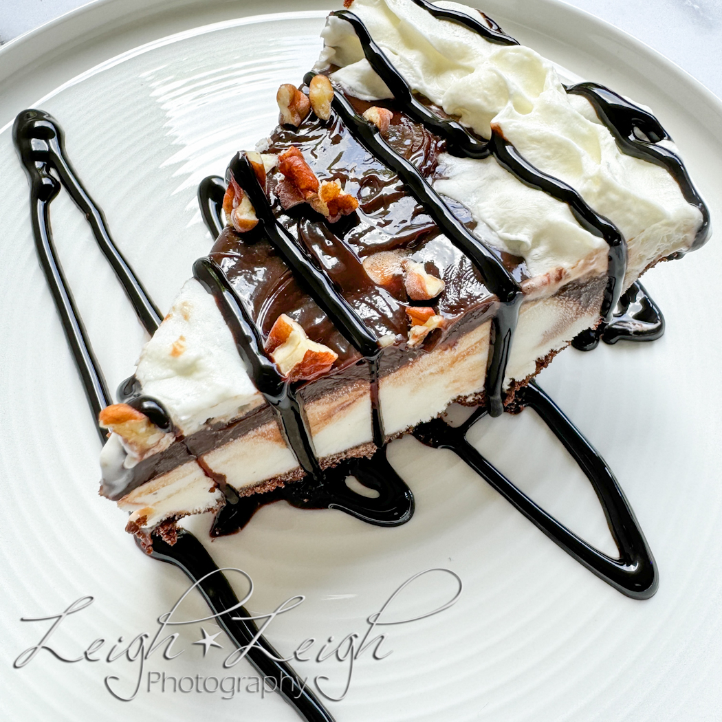 piece of ice cream pie with chocolate drizzled on top