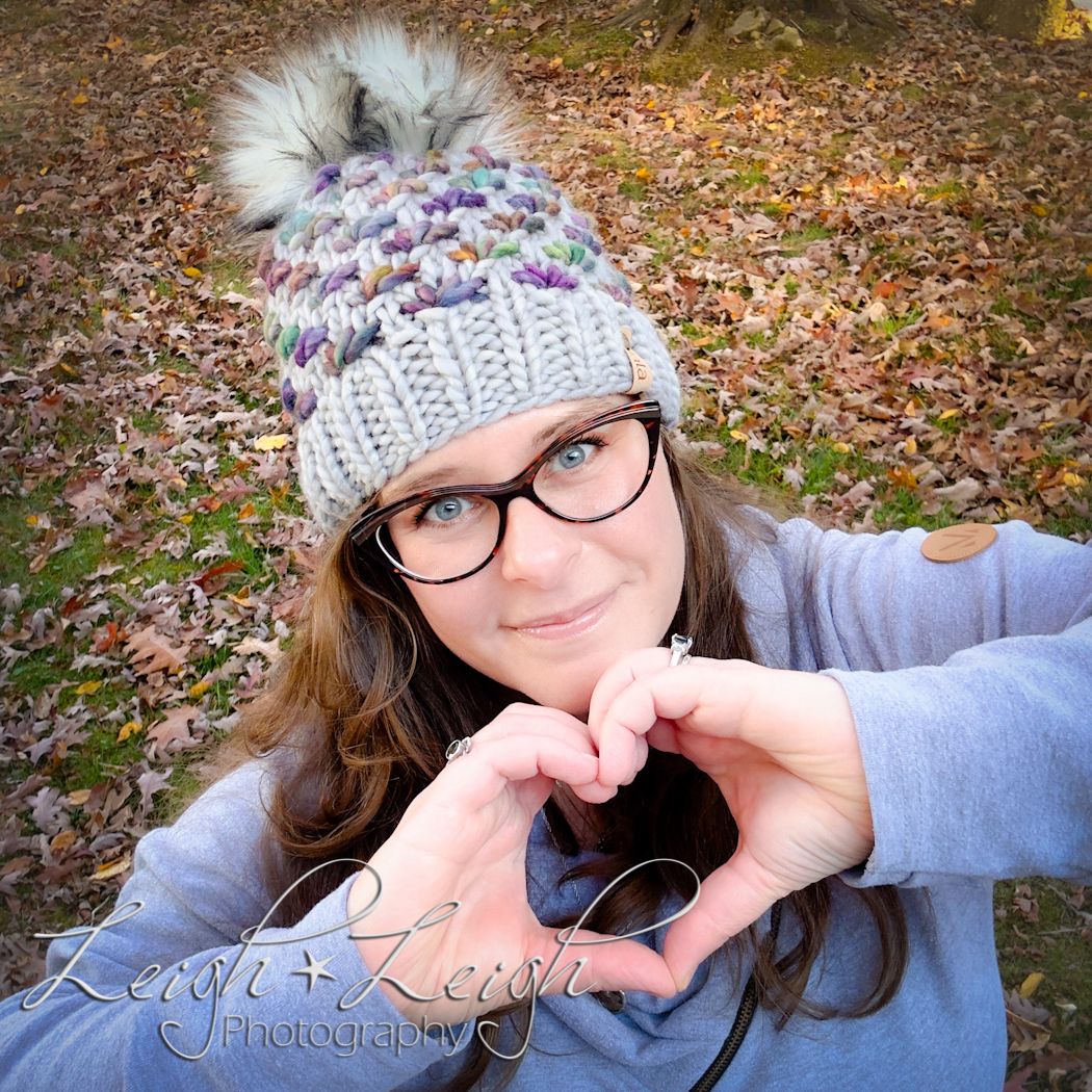 Rachel wearing pretty hat making a heart sign with her hands