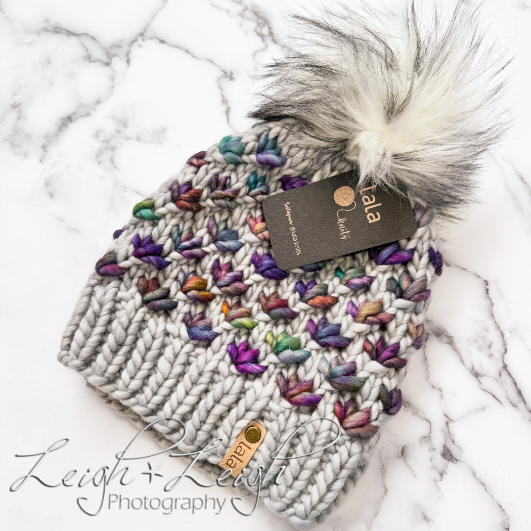 beautiful hand knitted hat against marble background