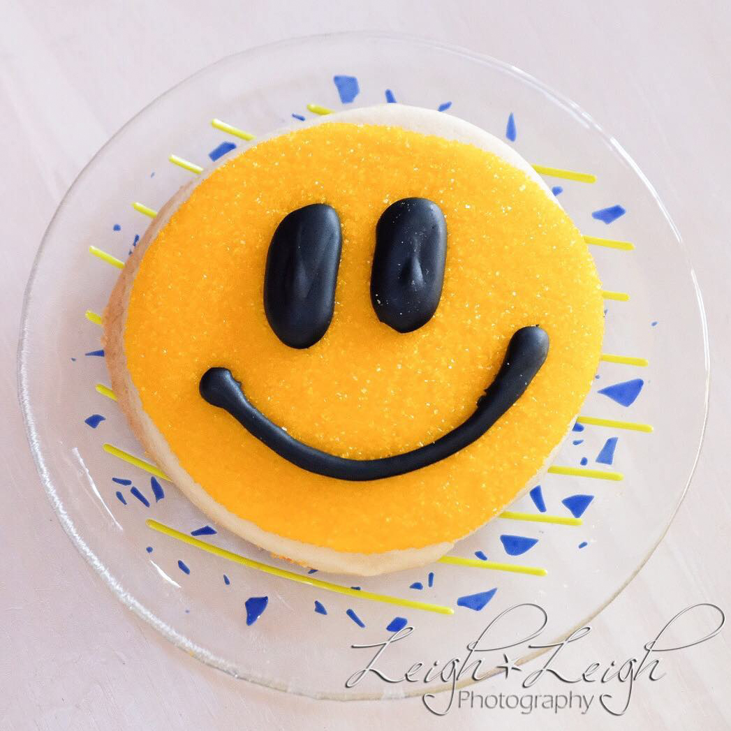 Smiley face cookie on a little plate