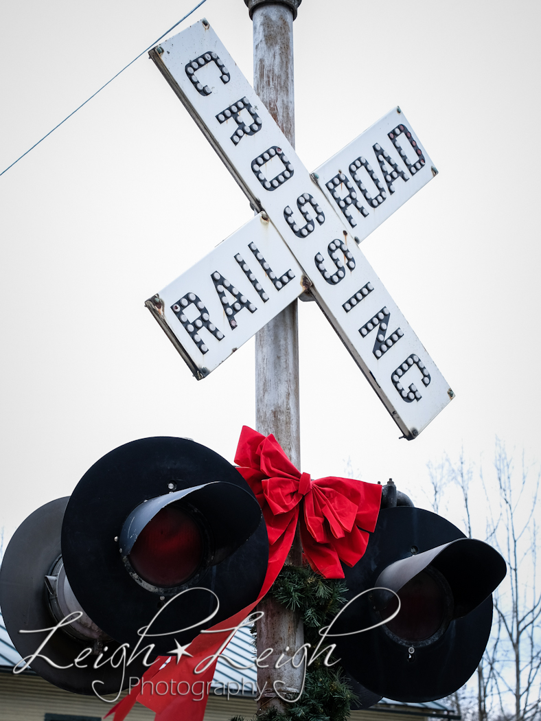 railroad crossing sign with red bow