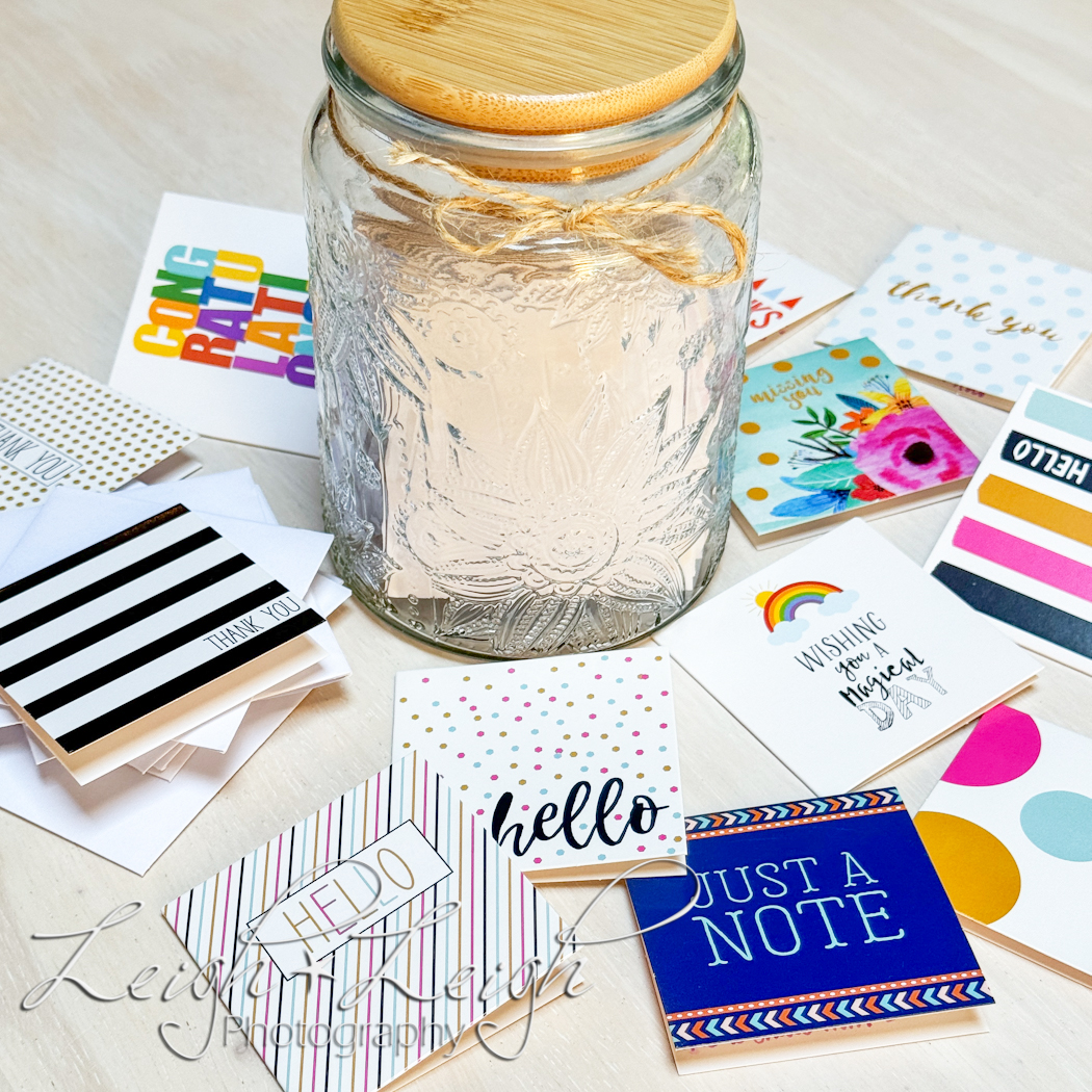 Glass jar surrounded by little colorful note cards