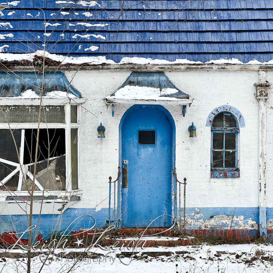 blue and white building with broken window