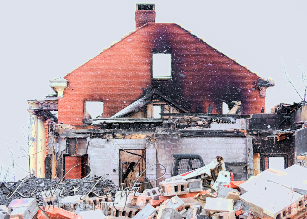 side of old governor's mansion after it burned - with excavator in front 