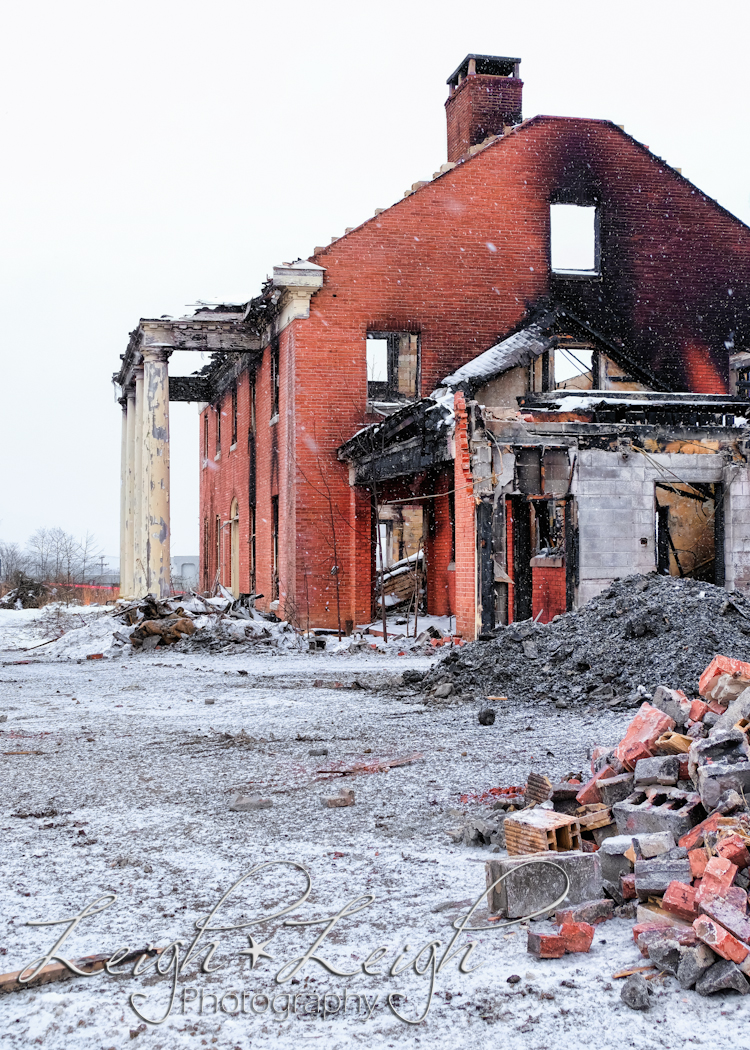 front of old governor's mansion after it burned - with excavator in front 