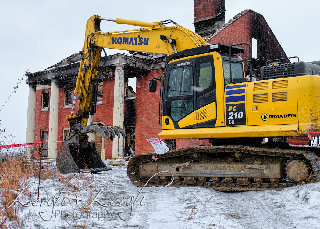 front of old governor's mansion after it burned - with excavator in front 