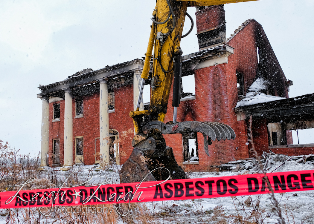 front of old governor's mansion after it burned - with excavator in front 