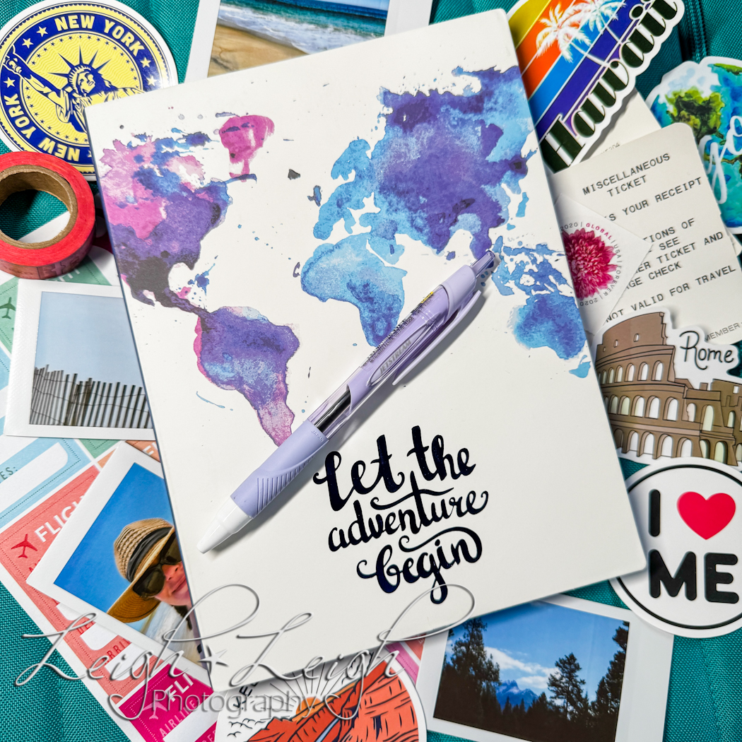 Travel Journal surrounded by stickers, washi tape, tickets and a pen